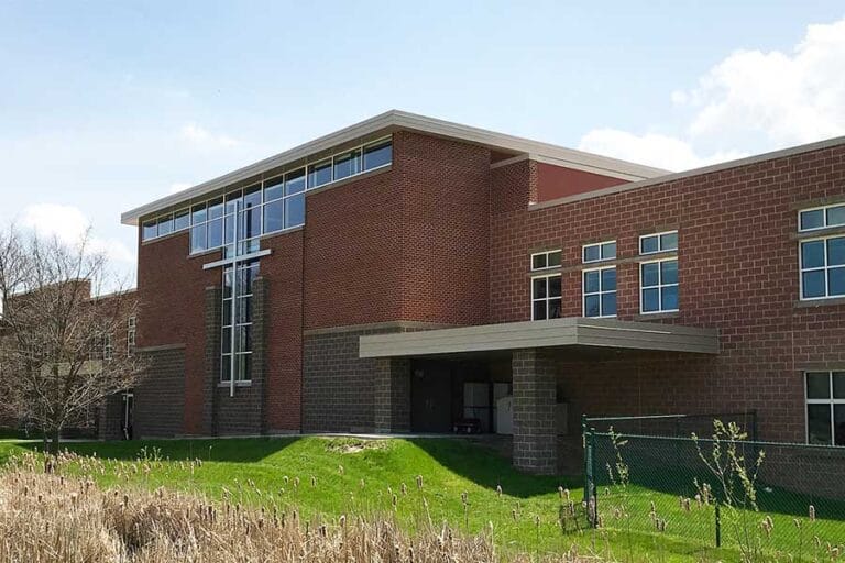 The exterior of Hales Corners Lutheran Church in Hales Corners, Wisconsin, illustrates how two colors and coursing type of masonry and masonry trim is used to direct attention to the Lutheran Cross